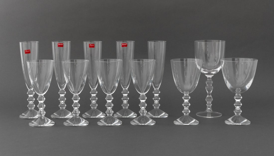 Baccarat "Vega" Crystal Glassware, 12 Pcs.: Collection of 12 Baccarat "Vega" Crystal Glassware Pieces, comprising: (5) five champagne flutes, (5) five port wine glasses, (1) one tall water goblet, and (1) one red wine glass, each with acid-etch