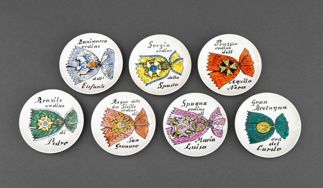 Fornasetti "Al Merito" Porcelain Coasters, 7: Set of Seven Piero Fornasetti "Al Merito" Porcelain Coasters, with painted embellishments to the lithograph medals, marked "Al Merito / Fornasetti Milano / Made in Italy" to the underside. Each: 4" Di