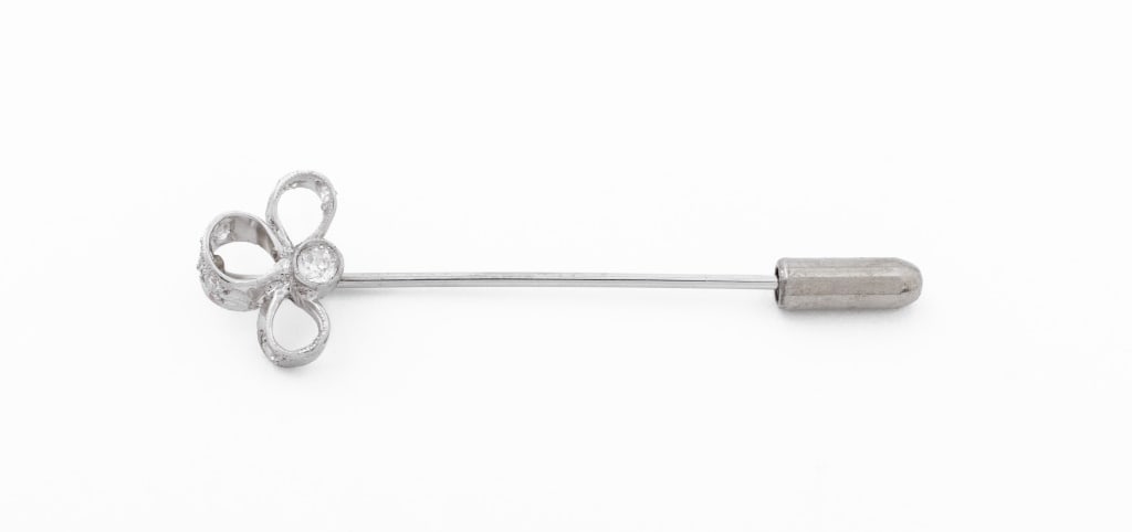 Platinum 14K White Gold Diamond Stick Pin: Platinum and 14K White Gold Diamond Stick Pin, decorated with 1 old European cut diamond weighing approx. 0.12 carat, further adorned with 7 single cut diamonds weighing a total of approx. 0.23 carat,
