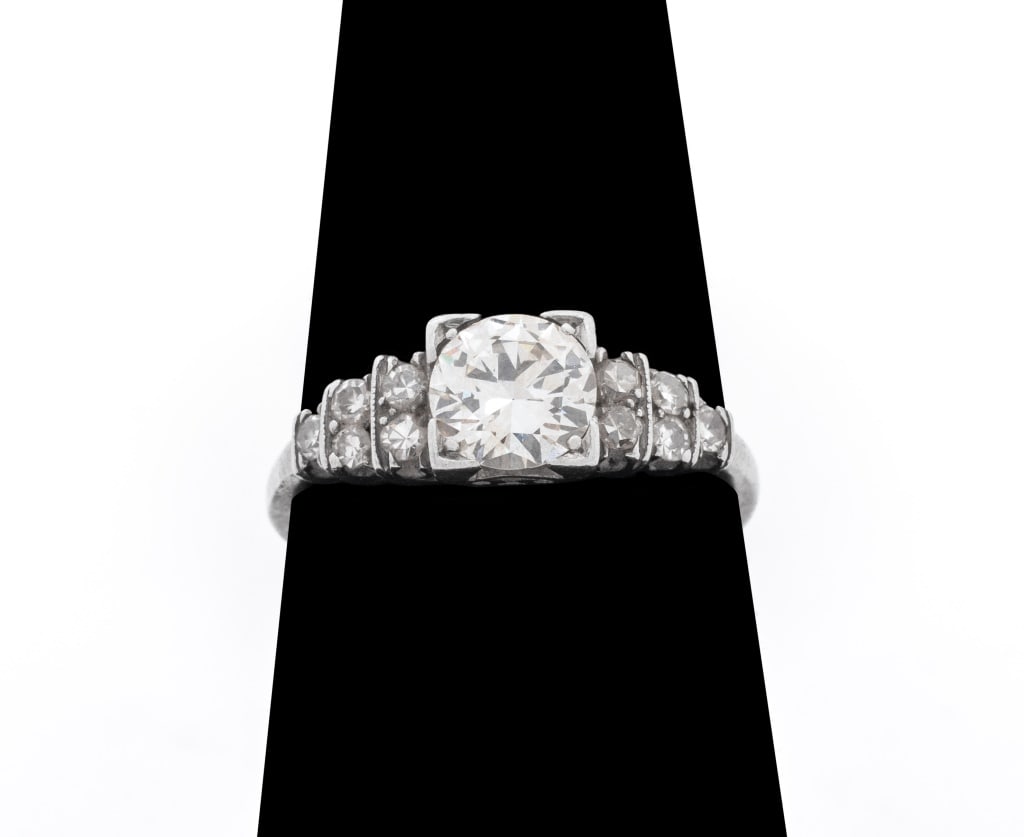 Platinum Diamond Ring: Platinum Diamond Ring, featuring one prong set centered round brilliant cut diamond, J-K color, SI1 clarity, weighing approx. 0.75 carat, further adorned with 10 single cut diamonds weighing a total o