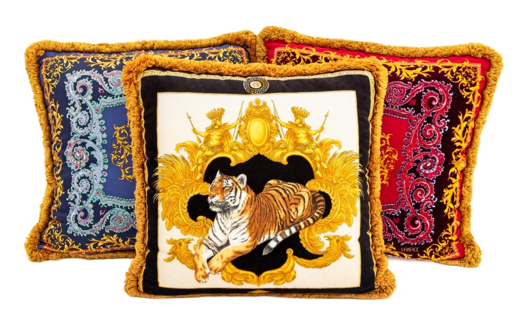 Atelier Versace Throw Pillows, 3: Group of Three Atelier Versace Throw Pillows, comprising: pair in red and blue paisley pattern and one with reclining tiger motif. 16" H x 16.5" W. Provenance: From a New York City Collection. Keyword