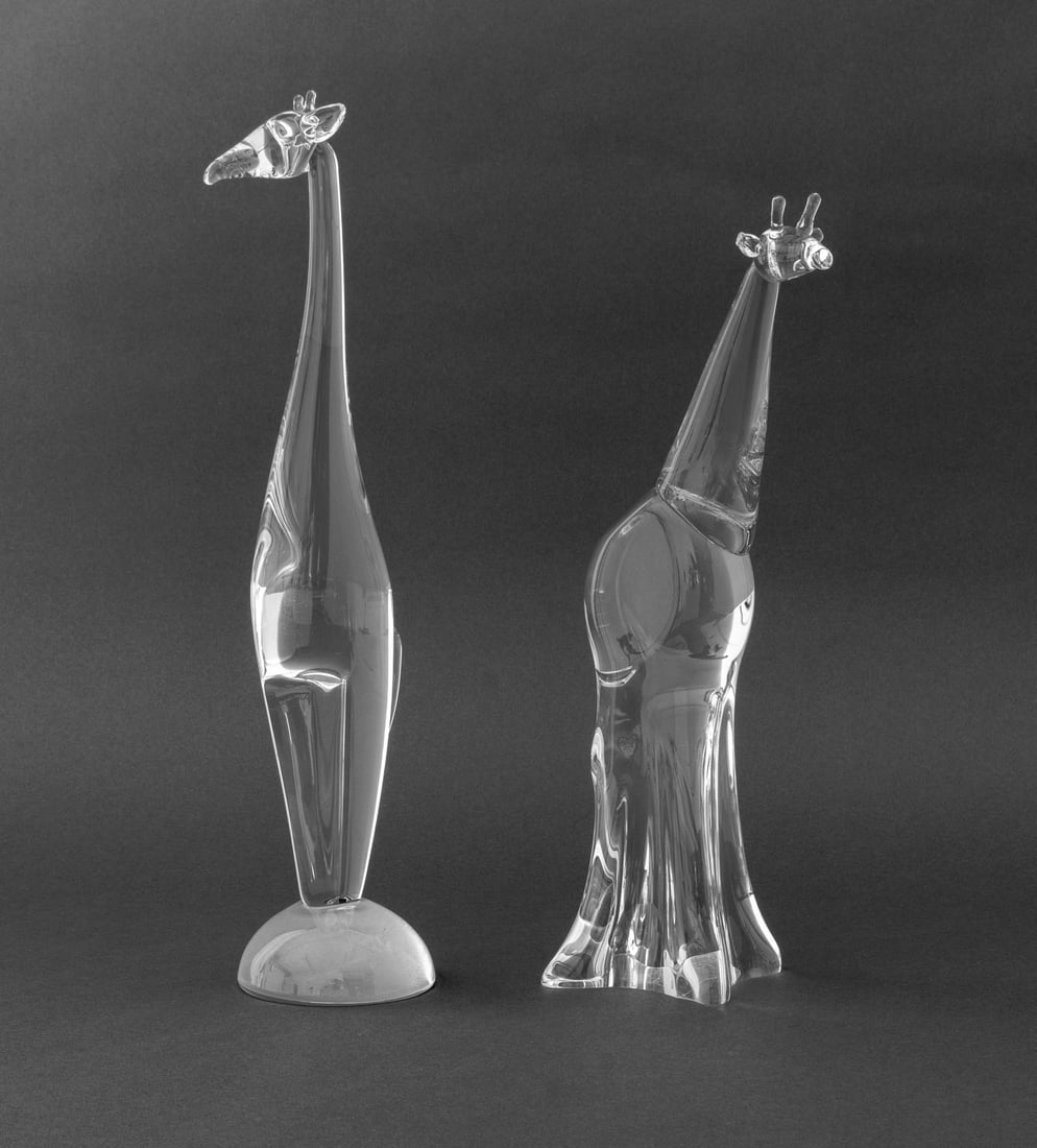 Steuben Clear Art Glass Giraffe Sculptures, 2: Two Steuben Clear Art Glass Giraffe Sculptures, comprising: one on half dome frosted base, marked "Steuben" and numbered edition "50/200" to the underside and one marked "Steuben" to the underside. Ta