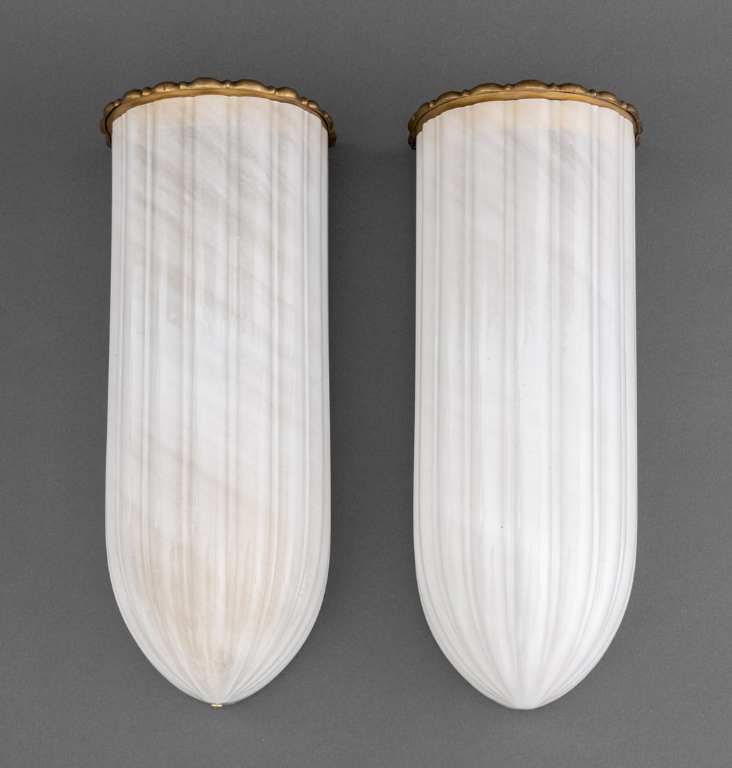 Art Deco Style Gilt Metal & Milk Glass Sconces, 2: Pair of Art Deco Style Gilt Metal and Milk Glass Wall Sconces, the gilt metal frame supporting reeded milk glass shade. 14" H x 6" W x 4.75" D. Provenance: Property from a 900 Park Avenue Estate. Keyw