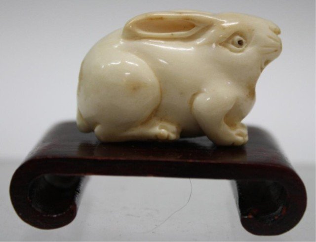 Carved Ivory Rabbit Bead w/ Painted Eyes: Carved ivory rabbit bead with brown painted eyes; unmarked. Dimensions: 1"H x 1-1/2"W x 3/4"D