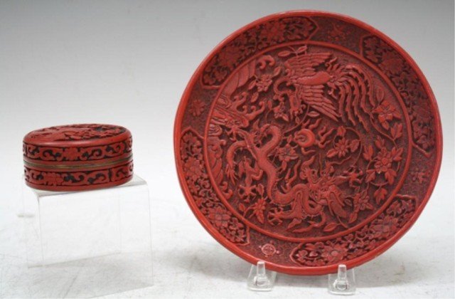 Chinese Lot of Cinnabar Plate & Box: Lot of cinnabar plate with a phoenix and dragon and a cinnabar box with floral design and blue enamel interior, China; plate is marked. Dimensions: plate: 1"H x 7-5/8" diameter; box: 1-1/4"H x 3" diam