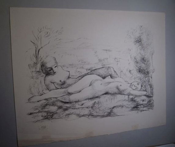 Polish Lithograph Nudes After Moise Kisling: Depicting two nude women reclining in a landscape, the woman in the foreground lies with her body cascading over rocks, her left arm folded behind her head, her left leg slightly bent and tucked under