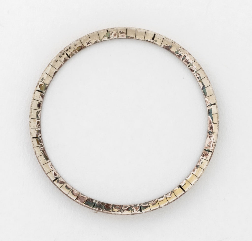 Rolex 31C-1530-2 Stainless Steel Loose Bezel: Rolex Genuine 31C-1530-2 Stainless Steel Loose Bezel, marked "T Swiss T", in original wax paper packaging. 29mm Diameter. Provenance: From a Manhattan Collection. Keywords: Watch parts, Time adjuster,