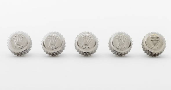 Rolex, Etc. Stainless Steel Loose Crown, 5 Pcs.: Collection of Five Stainless Steel Loose Crowns, comprising: (4) Rolex genuine submariner triplock and (1) Tudor. Each: 7mm Diameter. Provenance: From a Manhattan Collection. Keywords: Watch parts, Ti