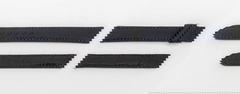 Cartier Watch Straps, 2 Pcs.: Two Cartier Watch Straps, comprising: black alligator for deployment buckle, marked "Cartier" and navy blue lizard, marked "1AQDAA08 / Cartier". Larger: 15mm x 117mm. Provenance: From a Manhattan Coll