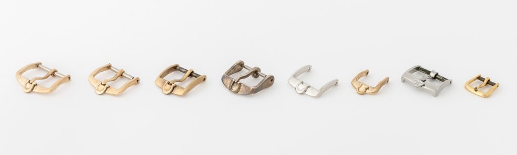 Jaeger-LeCoultre, Etc. Loose Watch Buckles, 8 Pcs.: Collection of Eight Designer Loose Watch Strap Buckles, comprising: (2) two Jaeger-LeCoultre, one stainless steel, one gold-tone and (6) six Omega, one silver, one stainless steel, and (4) four gold-t