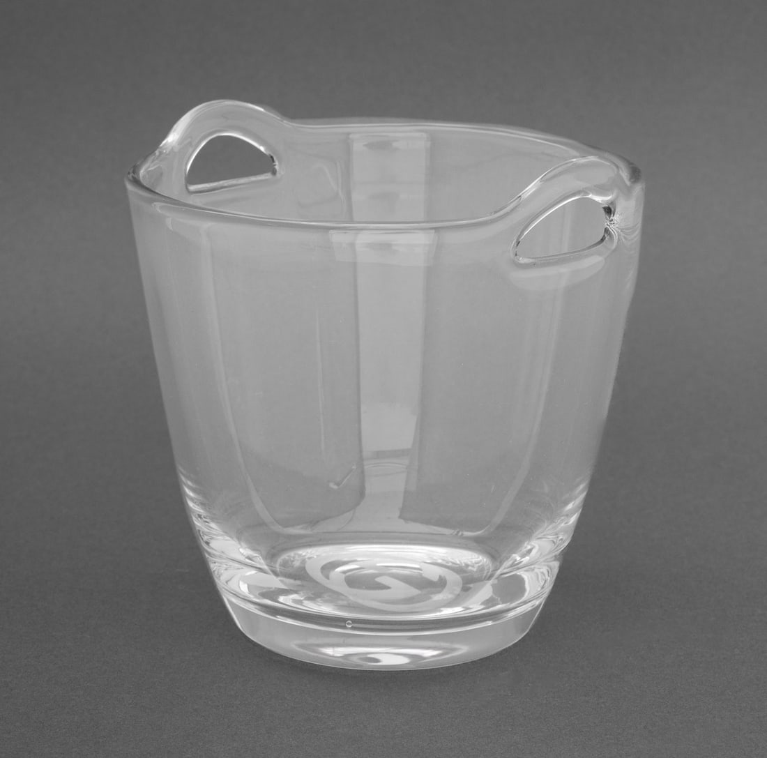 Gucci Crystal Ice Bucket: Gucci Crystal Ice Bucket, with two handles, marked with interlocking "GG" mark to the underside. 6" H x 6.25" W x 6" D. Provenance: From an 880 Fifth Avenue Collection. Keywords: Ice pail, Champagne b