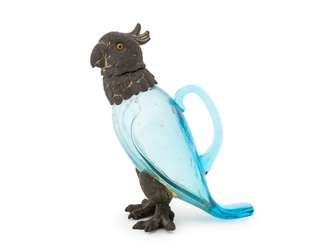 Cockatoo Form Blue Glass Claret Jug: Cockatoo Form Blue Glass Claret Jug, white metal head and feet, with handle. 8.25" H x 6.5" W x 3.75" D. Provenance: From an Upper West Side, New York City Estate. Keywords: Barware, Drinkware, Tablew