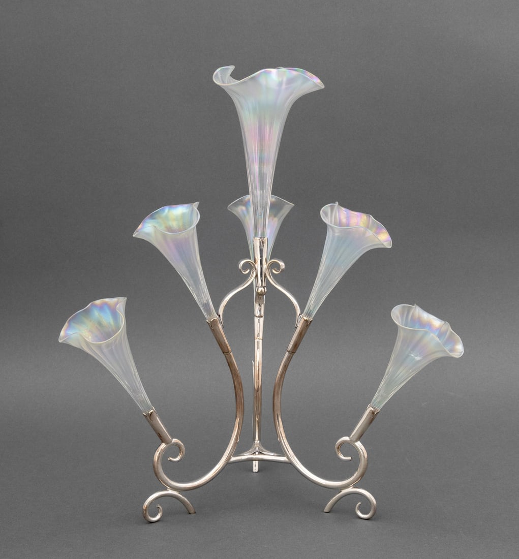 Floriform Iridescent Glass Silver Plate Epergne: Floriform Iridescent Glass Trumpet Silver Plate Epergne, with six trumpets (one lacking) and maker's mark to underside of stand. Overall: 14.75" H x 13" Diameter. Provenance: From a Long Island Estate