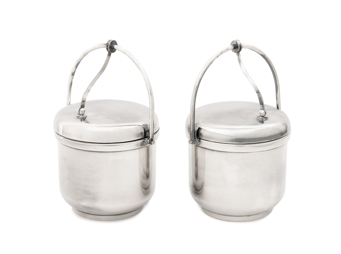 Modern Silver Plate Ice Buckets, Pair: Pair of Modern Silver Plate Ice Buckets, each with swing hinged lid and white composite liner, unmarked. 12" H x 8.75" W x 7.5" D. Provenance: From a Long Island Estate. Keywords: Ice pail, Wine coole