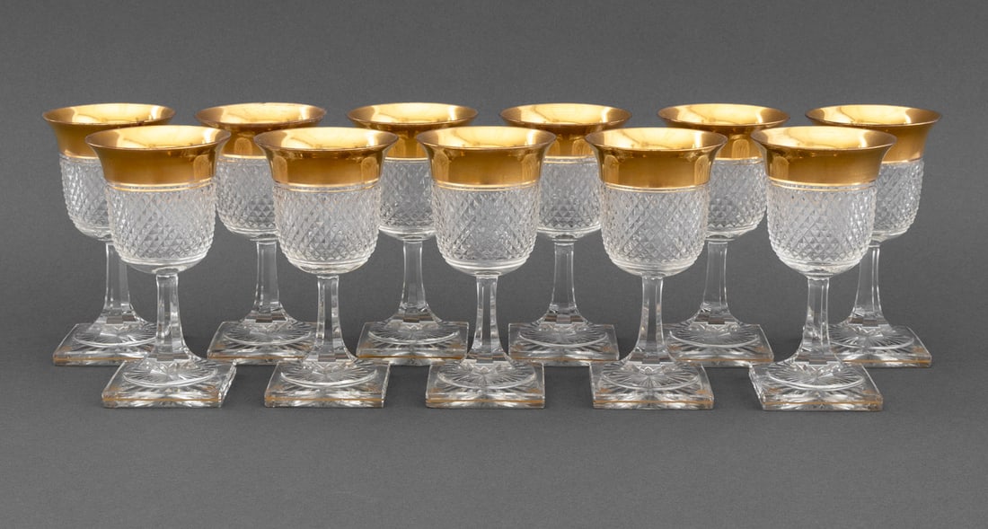 Cut Crystal and Gilt Encrusted Wine Glasses, 11: Set of Eleven Cut Crystal and Gilt Encrusted Wine Glasses, diamond cut pattern and square base with gilt decoration, apparently unmarked. 6" H x 2.75" W x 2.75" D. Provenance: From an Upper West Side,