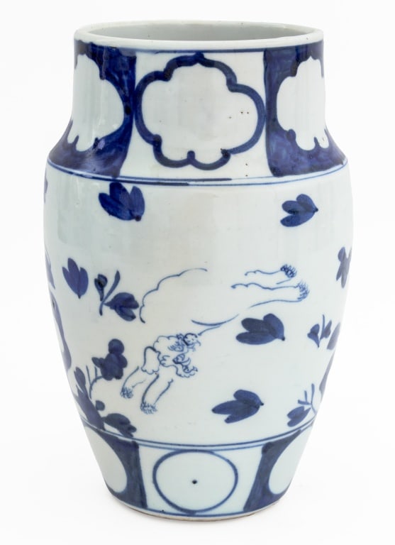 Japanese Blue and White Porcelain Flared Vase: Japanese Blue and White Porcelain Flared Vase, decorated with foo dogs playing amongst a garden scene with scholar rocks and windblown leaves. 10.5" H x 6.5" Diameter. Provenance: From an East 72nd St