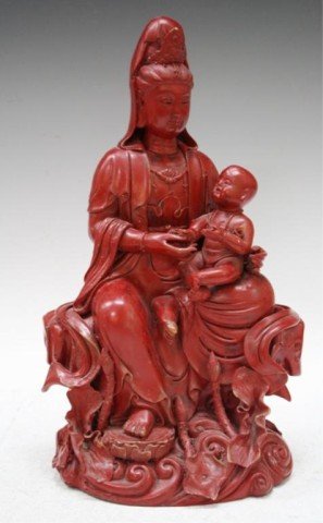 Chinese Red Soapstone Guanyin Carving: Carving of a seated Guanyin with a baby in her lap, red soapstone, China; unmarked. Dimensions: approximately 13"H x 7-1/2"W x 5-1/4"D