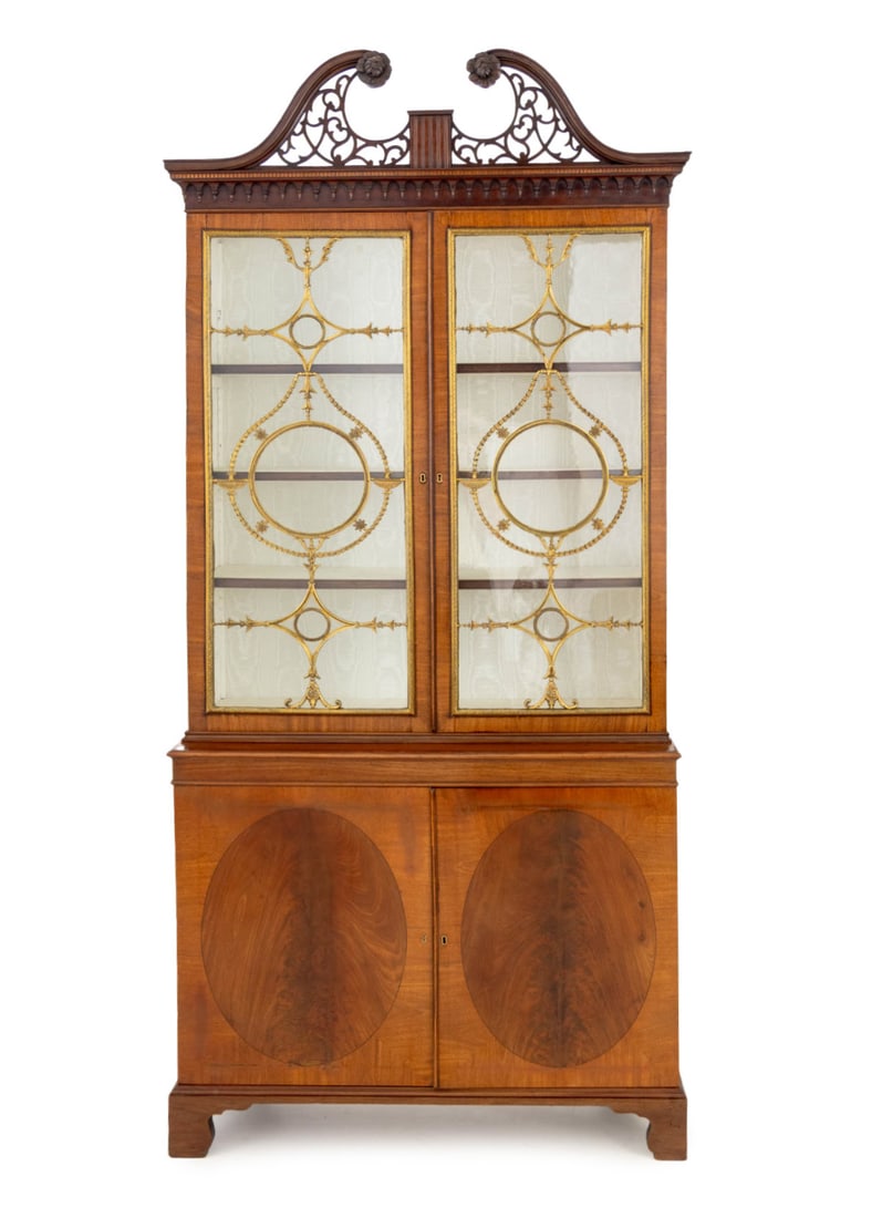 George III Gilt Metal Mounted Mahogany Cabinet: George III Gilt Metal Mounted Mahogany Cabinet Bookcase, in the manner of Thomas Chippendale, with pierced top above two glass paneled doors and three interior shelves atop a two-door cabinet. 88" H x