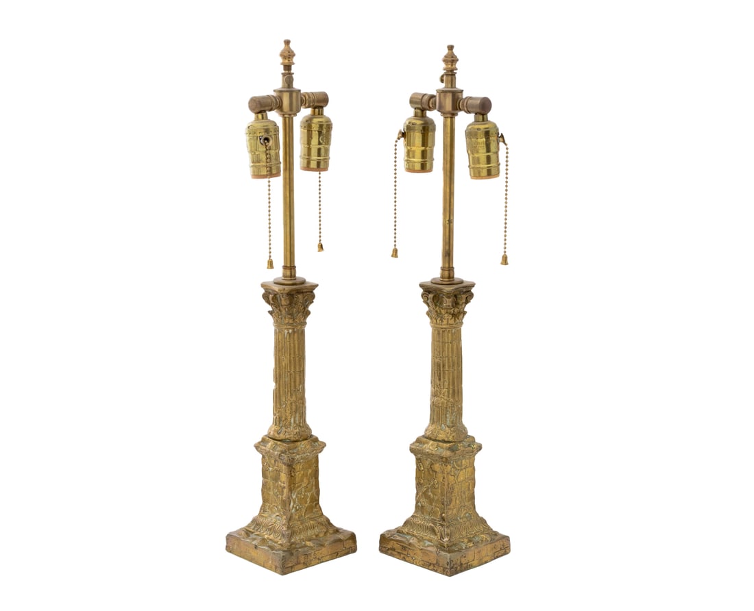 Neoclassical Style Brass Column Lamps, Pair: Pair of Neoclassical Style Brass Corinthian Column Table Lamps, the fluted columns mounted on floral decorated plinths . 21.5" H x 4" W x 4" D. Provenance: Property from a Bunny Williams decorated 5th