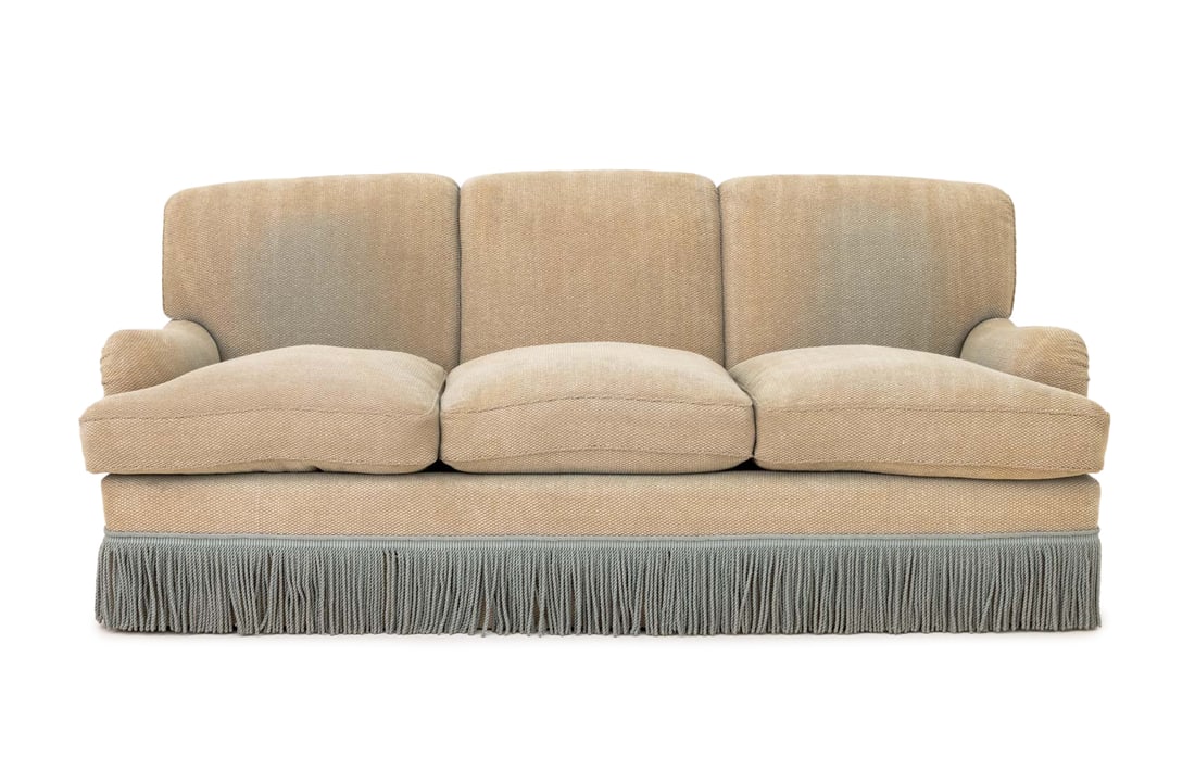 Modern Beige Upholstered Three-Seat Sofa: Modern Beige Upholstered Three-Seat Sofa, with blue tassel skirt. 33" H x 77" W x 37" D; seat: 20.5" H. Provenance: Property from a Bunny Williams decorated 5th Avenue Estate. Keywords: Vintage Furnit