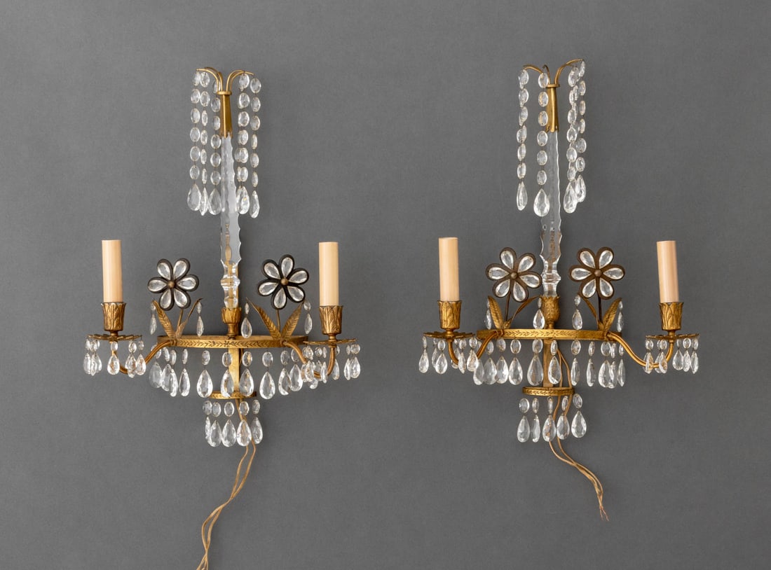 Maison Bagues Style Gilt Metal Sconces, Pair: Pair of Maison Bagues Style Gilt Metal Two-Light Wall Sconces, with rock crystal tear drop pendants and floral appliques. 17.5" H x 12.5" W x 6" D. Provenance: Property from a Bunny Williams decorated