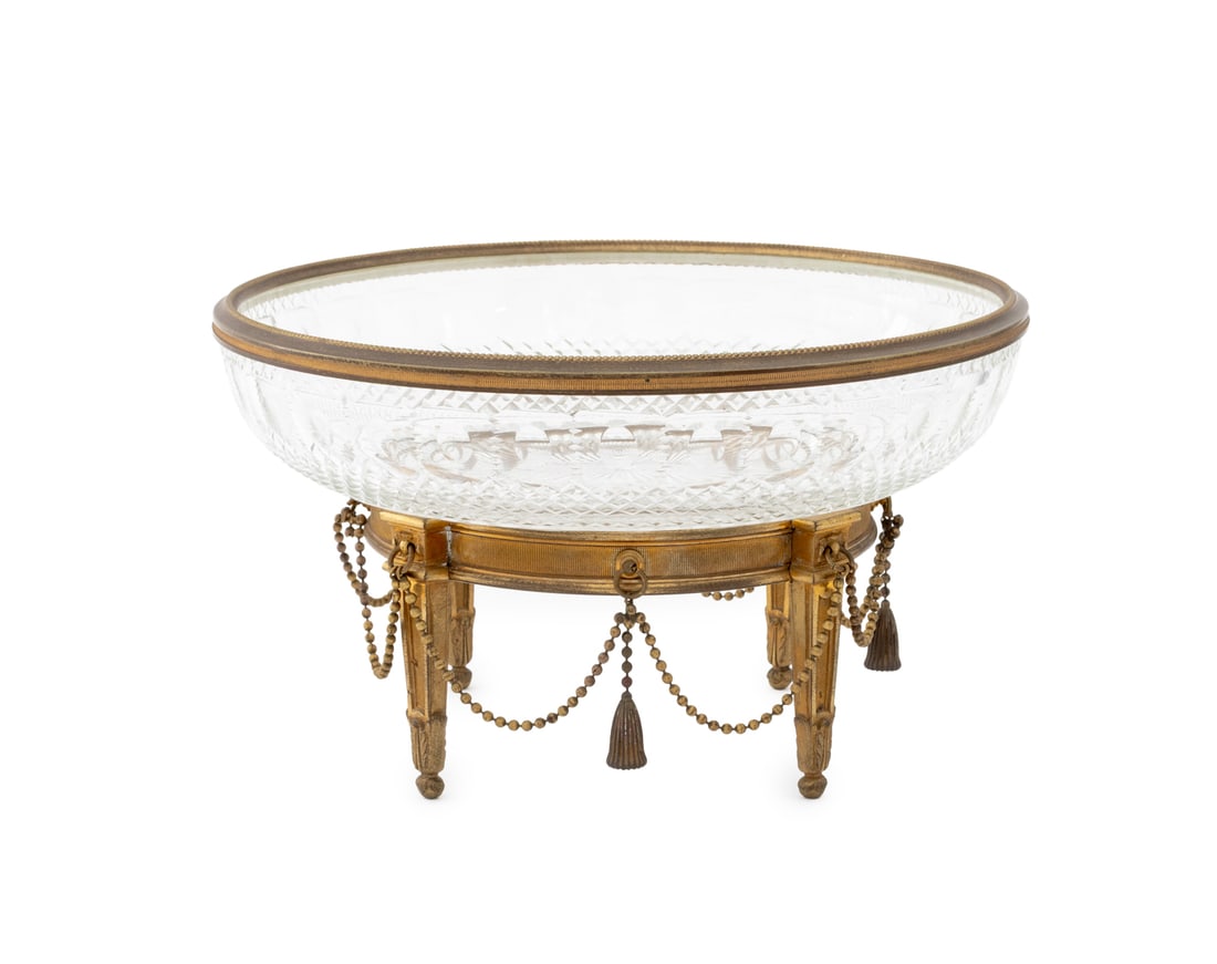 French Gilt Bronze Mounted Cut Glass Centerpiece: French Gilt Bronze Mounted Cut Glass Centerpiece Bowl, mounted on bronze garland atop four fluted tapered legs. 5.25" H x 9.25" Diameter. Provenance: From an 880 Fifth Avenue Collection. Keywords: Orm