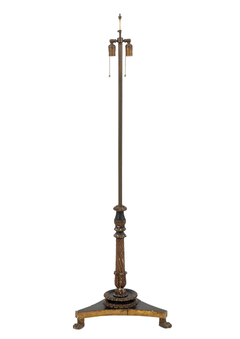 French Candlestick Mounted as a Floor Lamp: French Ecclesiastical Candlestick Mounted as a Floor Lamp, the ebonized carved wood base above three lion's paw feet and below a brass stem and two light bulb fittings. 58.5" H x 19" W x 19" D. Proven