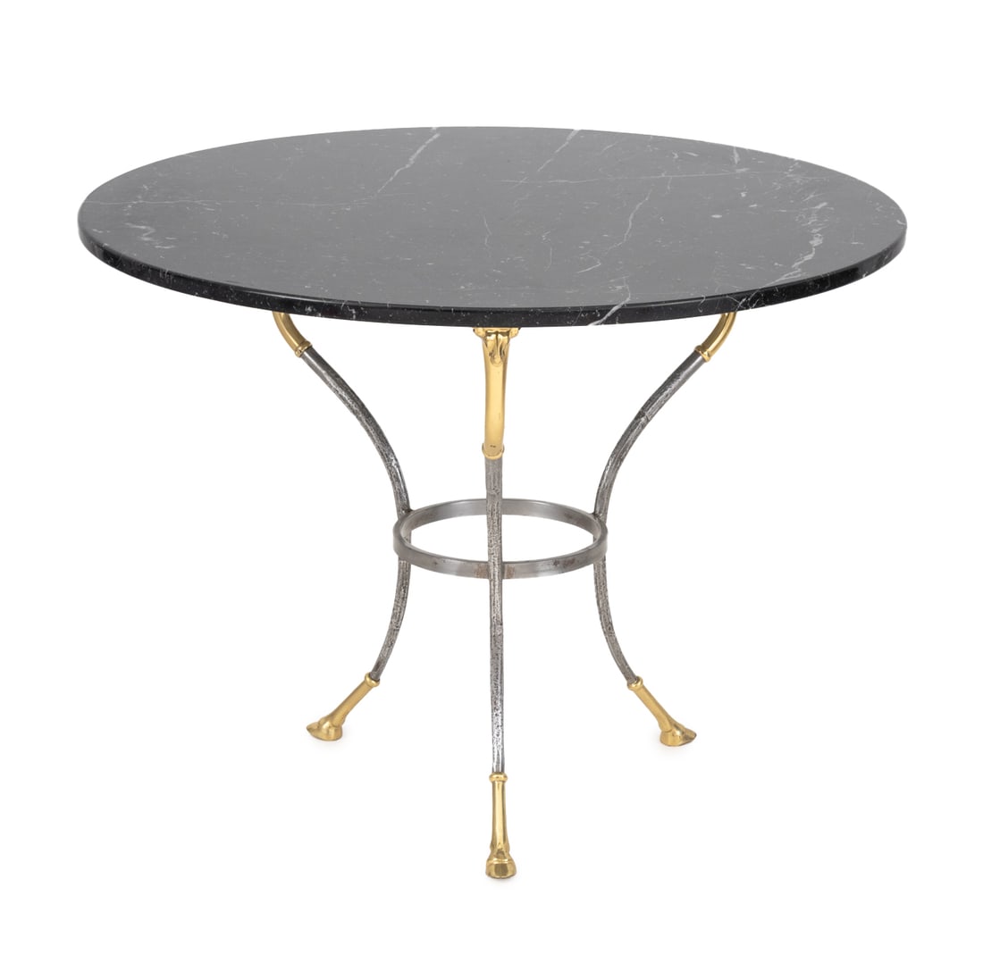 Maison Jansen Style Brass & Wrought Iron Gueridon: Maison Jansen Style Brass and Wrought Iron Gueridon, with black circular marble top above a circular iron frame with brass ox heads terminating in three hoof feet. 27" H x 36" Diameter. Provenance: Fr