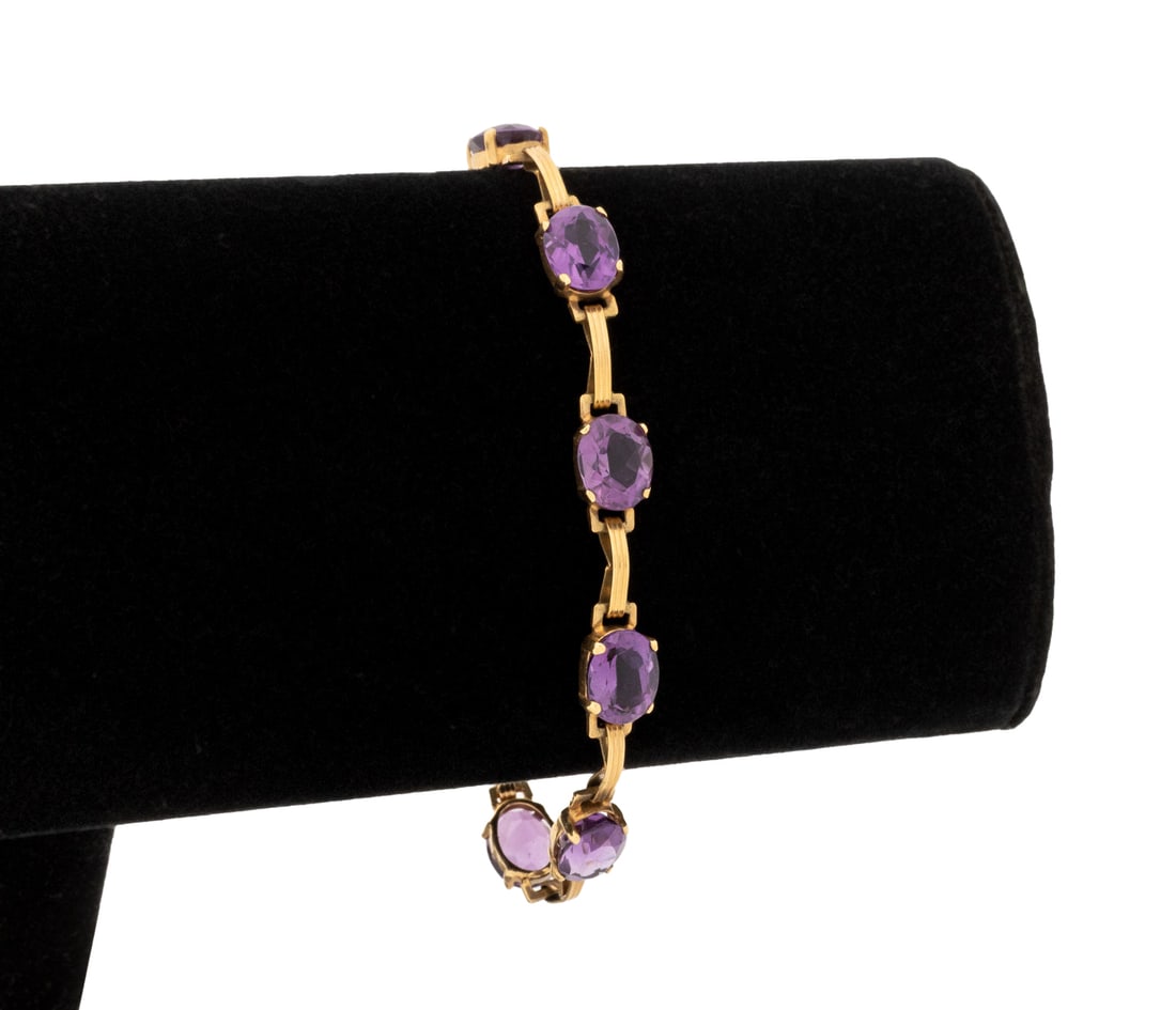 14K Yellow Gold Amethyst Bracelet: 14K Yellow Gold Amethyst Bracelet, featuring eight prong set oval brilliant cut amethysts weighing a total of approx. 14.00 carats, joined with spring ring clasp, marked: "14K". Measuring approx. 7 1/