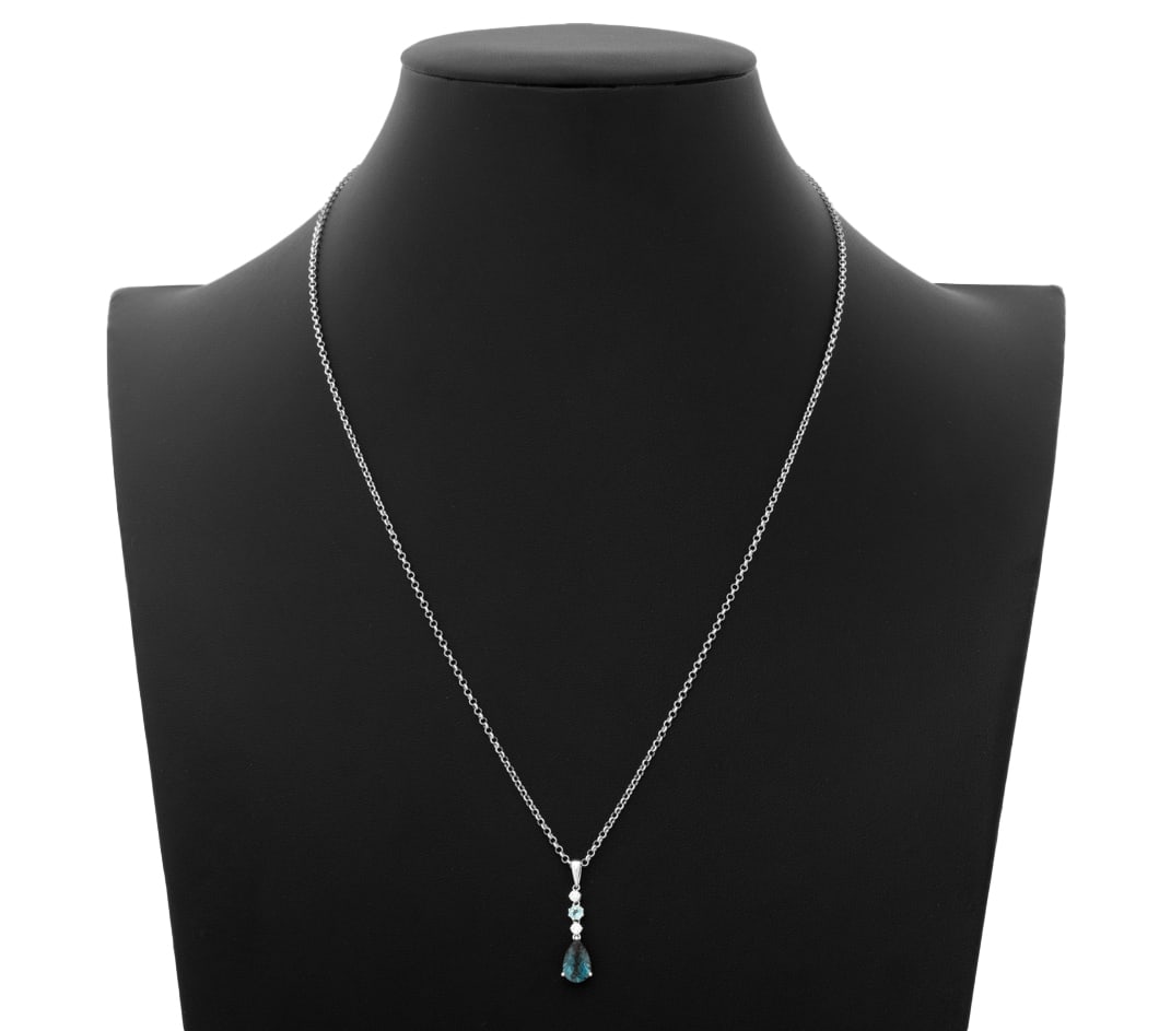 14K Topaz Diamond Pendant on Silver Necklace: 14K White Gold Topaz Diamond Pendant on Sterling Silver Necklace, featuring one detachable pendant, adorned with one prong set pear brilliant cut blue topaz weighing approx. 1.50 carats and one prong