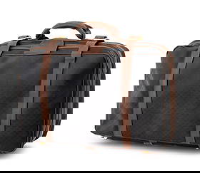 Gucci Monogrammed Black Canvas & Leather Suitcase: Gucci Monogrammed Black Canvas and Brown Leather Suitcase, with top handle and double buckle strap, the single zipper opening to black leather lining with white cotton double straps, marked "Gucci / M