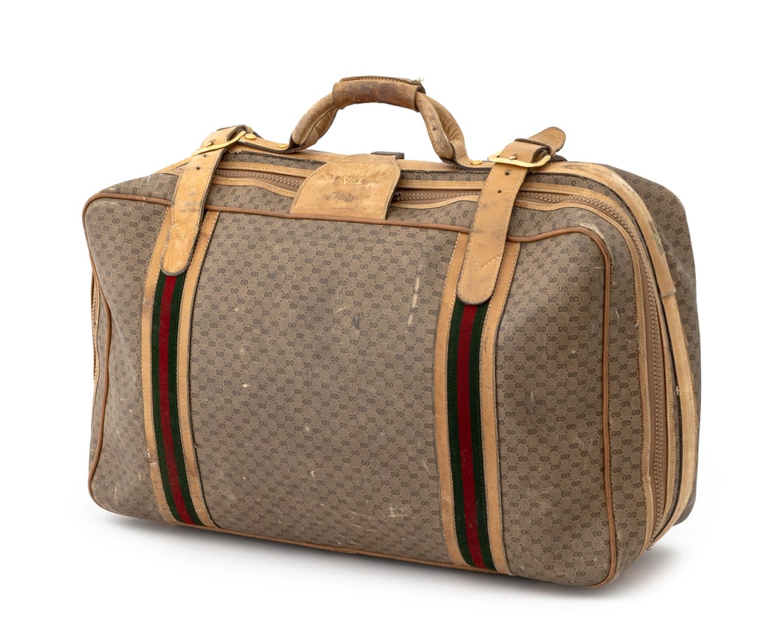 Gucci Monogrammed Canvas and Leather Suitcase: Gucci Monogrammed Canvas and Leather Suitcase, with green and red cotton stripes, with top handle and double leather closures, the single top zipper opening to one compartment with "Gucci" cotton inte