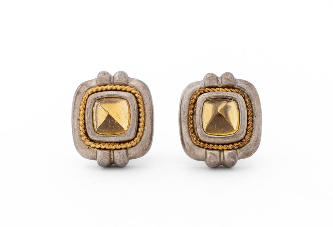 Tiffany & Co. 925 Silver 18K Gold Citrine Earrings: Pair of Tiffany and Company Sterling Silver and 18K Yellow Gold Sugarloaf Citrine Earrings, featuring two bezel and hidden prong set citrines weighing a total of approx. 4.50 carats, decorated with tw