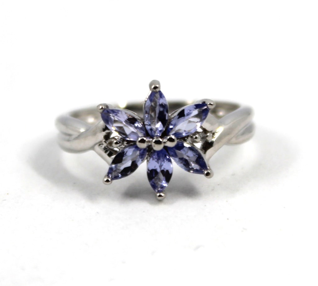 Modern 10K White Gold and Tanzanite Floriform Ring: Modern 10K White Gold and Tanzanite Floriform Ring, with six marquise-cut tanzanite stones in a floriform setting, marked "10K STS". Tanzanite approx. 0.80 ct. Ring size 6.75. Approx: 1.5 dwt. inclusi