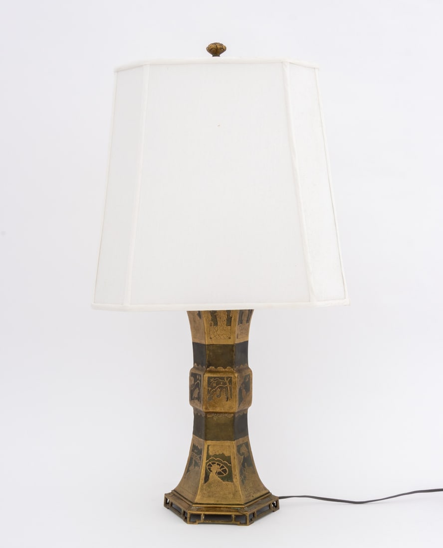 Chinese Figural Motif Brass Lamp: Chinese Figural Motif Brass Lamp, hexagonal column with figural, bird, and landscape scenes, with white cloth lampshade. 28.5" H x 15.5" W x 15.5" D. Provenance: From a 201 E 66th Street Estate.