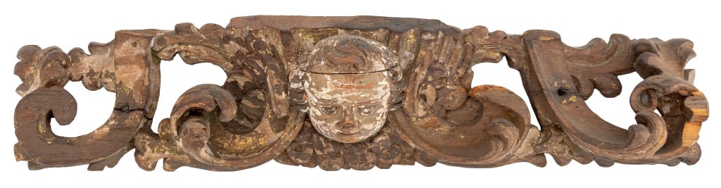 Baroque Painted Carved Wood Architectural Element: Baroque Gilt Painted and Carved Wood Architectural Element, scrollwork centering a cherubic masque. 6" H x 28" W x 4.5" D. Provenance: From a New York City Collection. Keywords: Ecclesiastical, Carvin