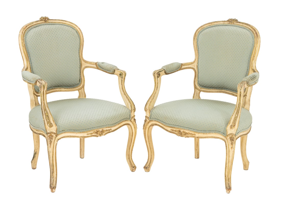 Louis XV Style Painted Fauteuils, 19th C., Pair: Pair of Louis XV Style Painted Fauteuils, late 19th century, each with carved and gilt bouquet crest, light blue upholstered seat, back, and arm rests on four cabriole legs with gilt accents. 36" H x