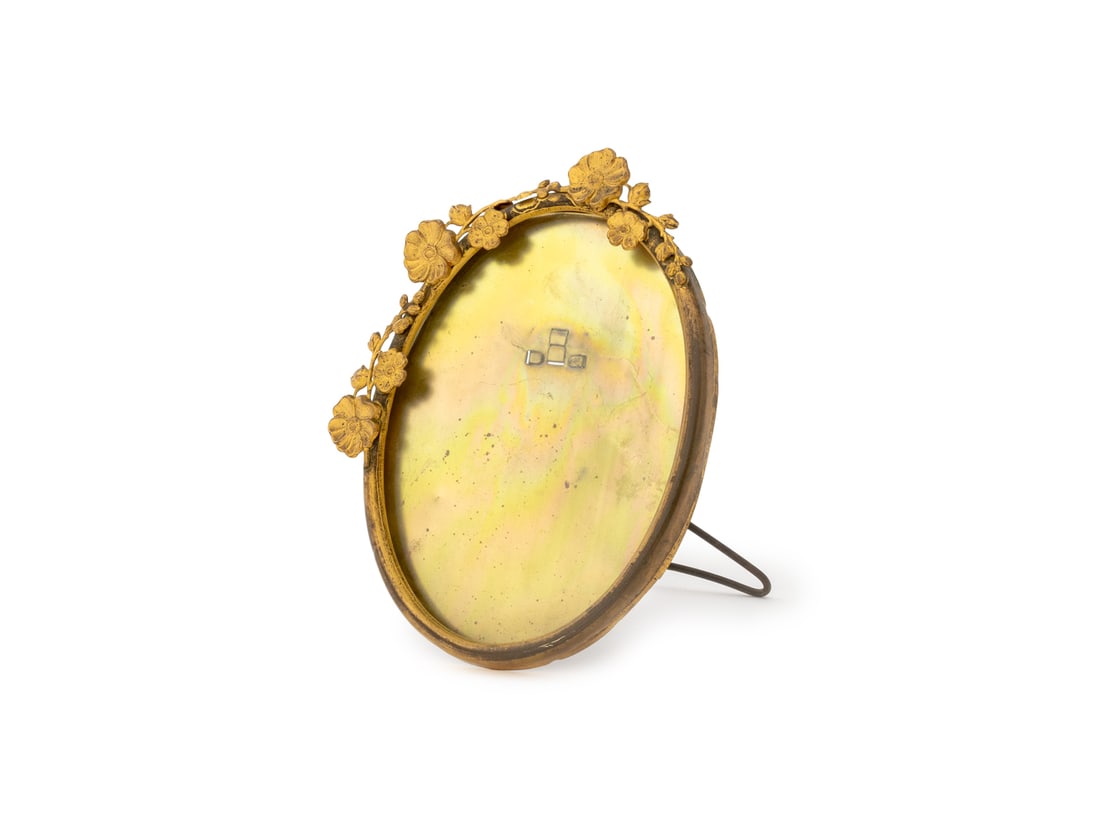 Art Nouveau Gilt Metal Floral Oval Picture Frame: Art Nouveau Gilt Metal Floral Motif Oval Picture Frame, with easel back stand. 5.75" H x 4.75" W x 3.75" D. Provenance: A New York City Collection. Keywords: Antiques, Photograph frame, Table decor, M