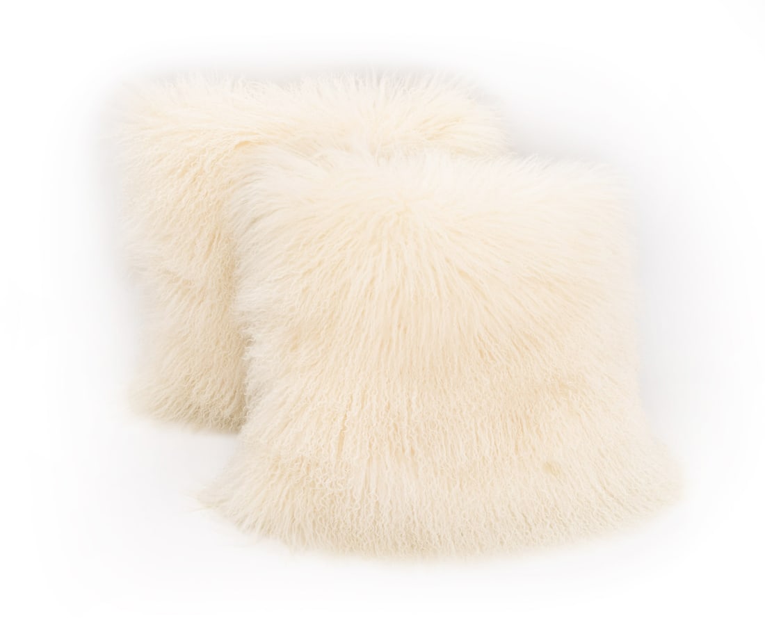 White Mongolian Lamb Pillows, Pair: Pair of White Mongolian Lamb Pillows. 22" L x 22" W x 6" D. Provenance: From a 422 East 72nd Street Estate. Keywords: Cushions, Lamb, Furs, Wool, Luxury goods, Interior design, Decorative Arts