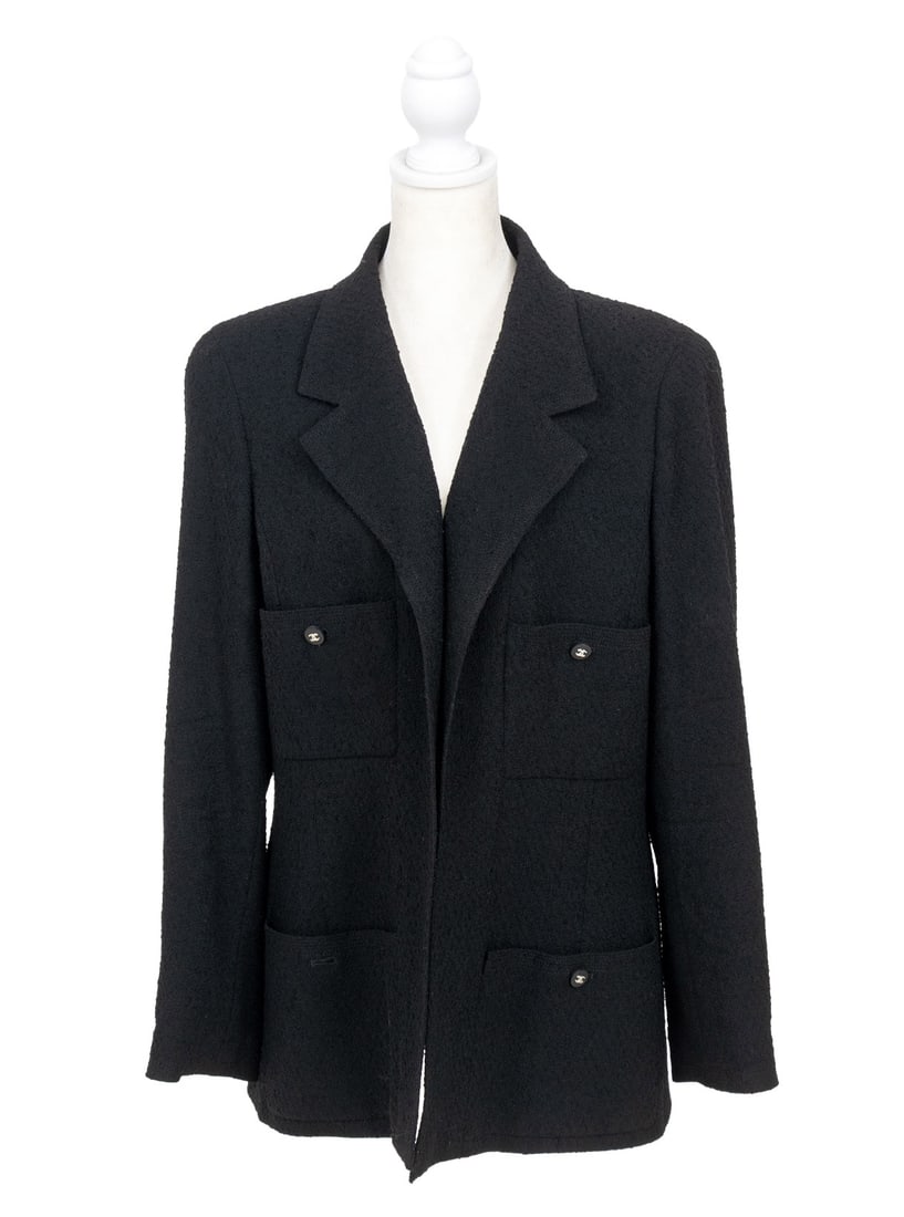 Chanel Boutique Black Wool Blazer: Chanel Boutique Black Wool Blazer, with black silk lining, four front button pockets and silver-tone chain trim to the bottom interior edge, with "Chanel / Boutique" label. Overall length: 28.5"; Shou