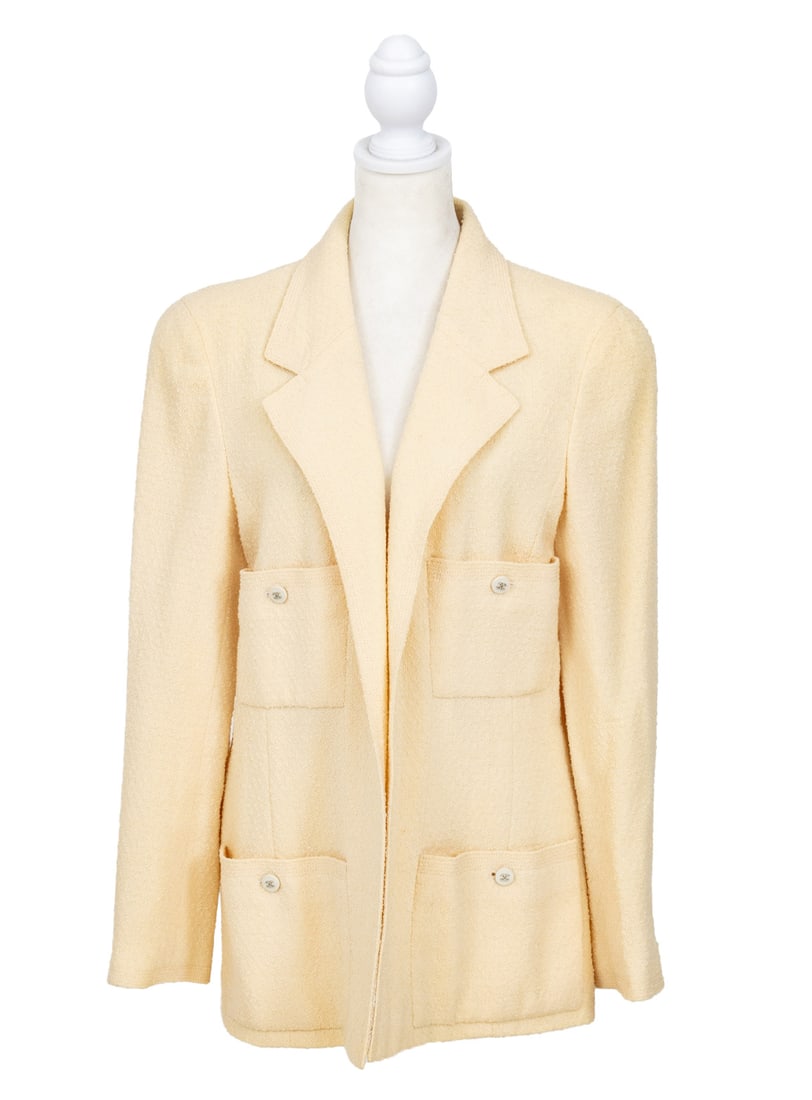 Chanel Boutique White Wool Blazer: Chanel Boutique White Wool Blazer, with four front button closure pockets having "CC" buttons and beige silk lining, "Chanel Boutique" label. Overall length: 30"; Shoulders: 16"; Bust: 38"; Waist: 36"