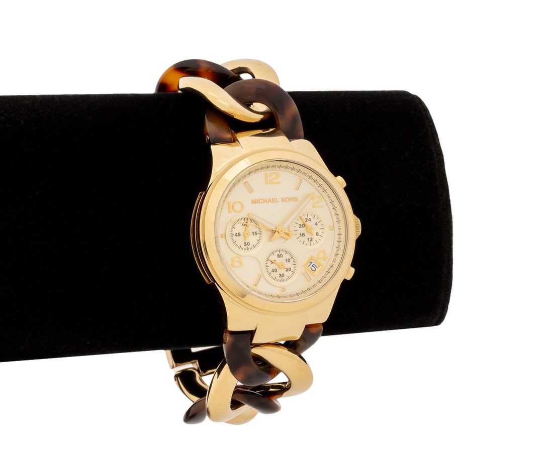 Michael Kors Runway Twist Gold-Tone Watch: Michael Kors Runway Twist Gold-Tone and Faux Tortoise Shell Wristwatch, the chronograph clock face with white enamel baton incides and arabic numeral numbers and stainless steel back case, marked "Mic