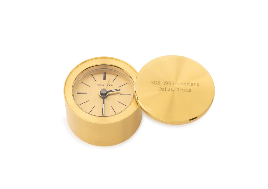 Tiffany & Co. Circular Brass Desk Clock: Tiffany and Company Circular Brass Desk Clock, with rotating lid engraved "AGS 1993 Conclave / Dallas, Texas" and black enamel baton indices, marked "Tiffany & Co. / Swiss", with Tiffany blue box and