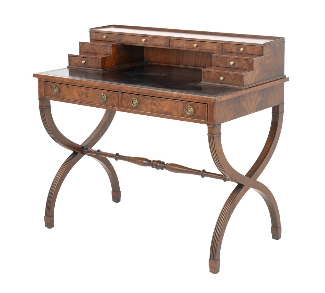 English Regency Flame Mahogany and Walnut Desk: English Regency Flame Mahogany and Walnut Desk, with eight short drawers above black leather writing surface and two drawers on X-form legs conjoined by central stretcher. 35.5" H x 39" W x 21.5" D. P