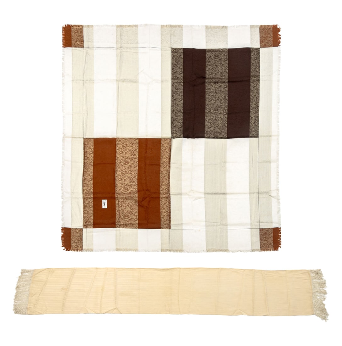 Yves Saint Laurent Silk Scarves, 2: Two Yves Saint Laurent Silk Scarves, comprising: cream colored stripe pattern scarf with white tassels, marked "YSL" in print and tan, brown and white stripes with silver thread embellishment, marked