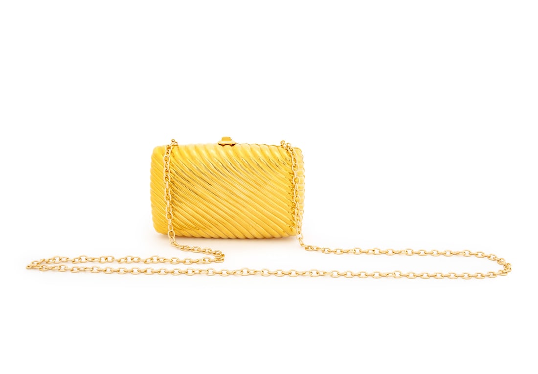 Judith Leiber Gold-Tone Metal Minaudiere: Judith Leiber Gold-Tone Metal Minaudiere, with optional chain link strap, plaque label inside. 4.5" H x 6" W x 1.5" D. Provenance: From the Estate of American Fashion Journalist and Editor-in-Chief