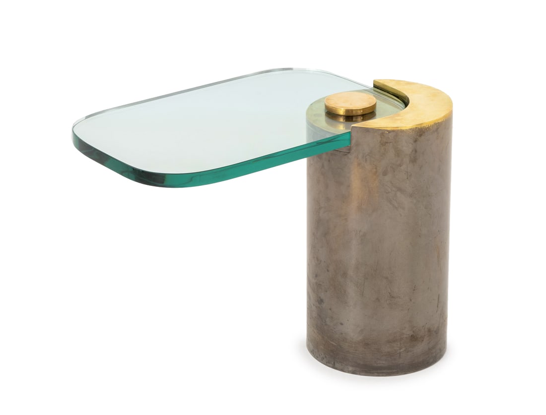 Karl Springer Sculptural End Table: Karl Springer Sculptural End Table, with glass top and gilt and gunmetal-tone brass cylindrical base. 18.25" H x 24" W x 17" D. Provenance: From a 422 East 72nd Street Estate. Keywords: Designer, Vint