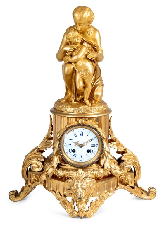 Louis XVI Style Ormolu Figural Clock, 19th C.: Louis XVI Style Ormolu Figural Clock, late 19th century, depicting a crouching Aphrodite with Cupid, above the circular enamel dial, strike on bell movement, the fluted pedestal mounted with acanthus