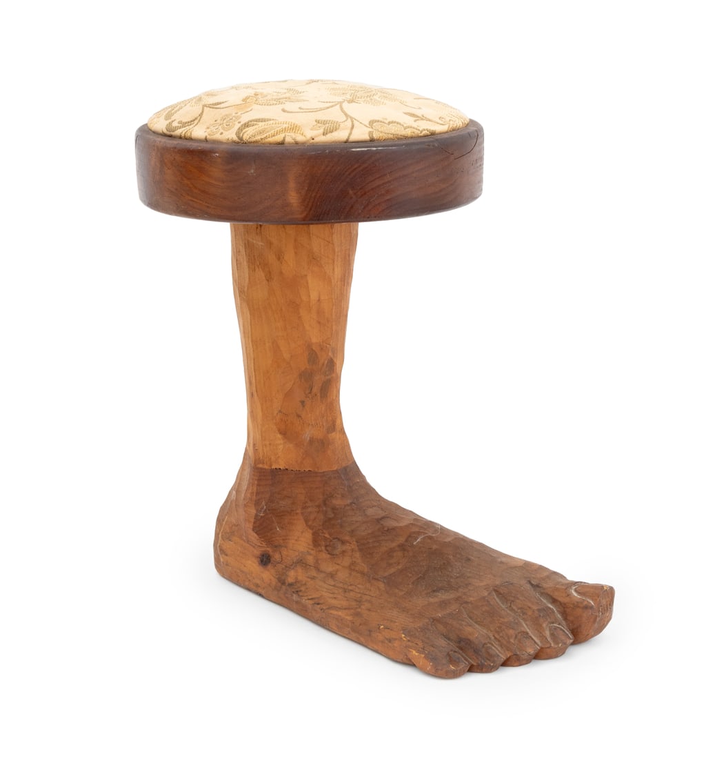 Folk Art Carved Wood "Foot" Stool: Folk Art Carved Wood "Foot" Stool, with cream floral upholstery, signed "Amidon" to underside. 15" H x 14.5" W x 9" D. Provenance: From a 201 E 66th Street Estate. Keywords: Vintage Furniture, Seating
