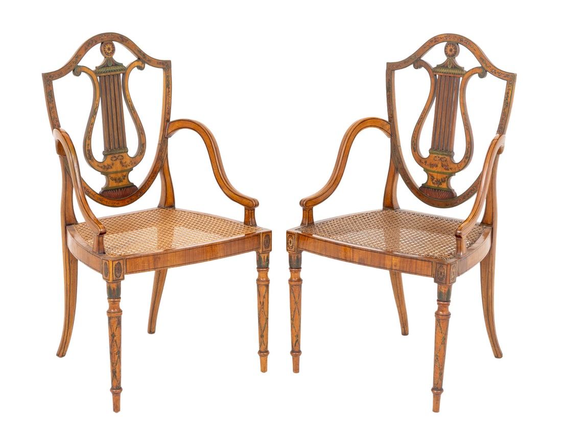 George III Style Painted Satinwood Armchairs, Pair: Pair of George III Style Paint-Decorated Satinwood Arm Chairs, each with lyre form splat and cane paneled seat. 37" H x 27.75" W x 16.5" D; seat: 17" H. Provenance: From a New York City Collection.